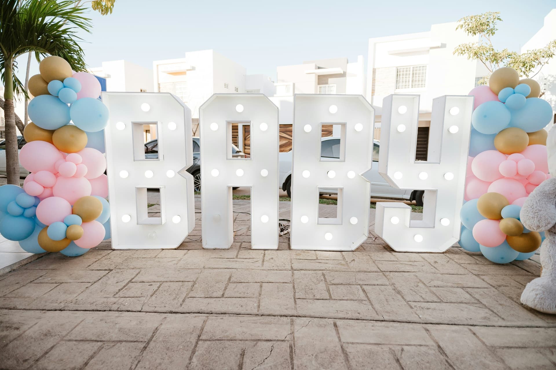 Baby shower display with illuminated baby letters and balloons